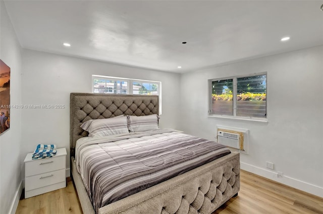 920 SW 8th Ct, Miami, FL 33130 - bedroom featuring an AC wall unit, light wood finished floors, and recessed lighting