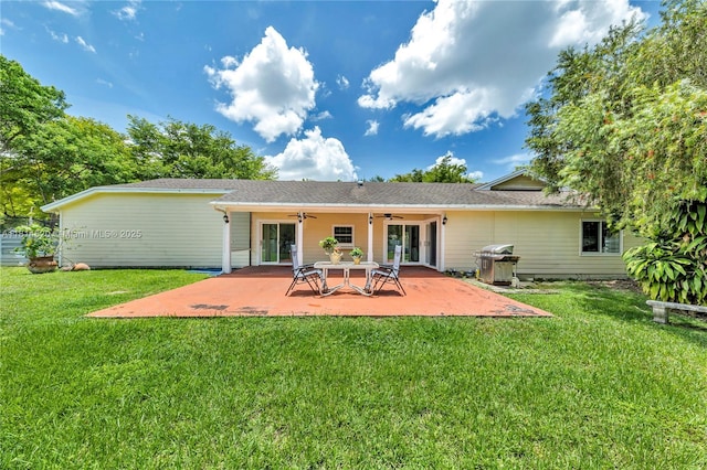 14630 SW 147th Ct, Miami, FL 33196 - back of property with a ceiling fan, a patio, and a lawn