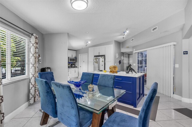 15240 SW 188th St, Miami, FL 33187 - dining area featuring light tile patterned flooring and a textured ceiling