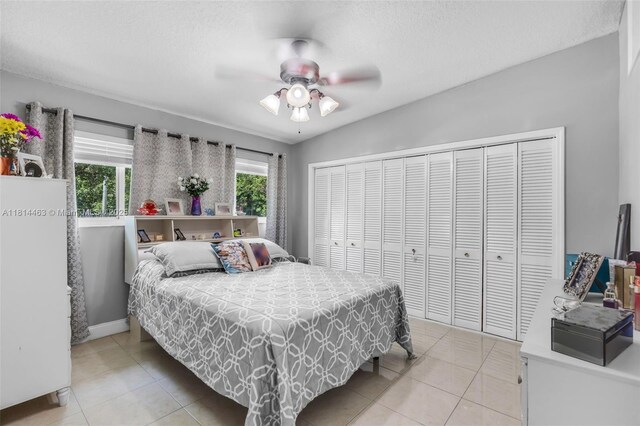 15240 SW 188th St, Miami, FL 33187 - bedroom featuring light tile patterned flooring, a closet, and a ceiling fan
