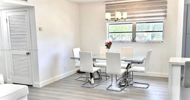 5300 Washington St Unit T227, Hollywood, FL 33021 - dining space with baseboards, a chandelier, and wood finished floors