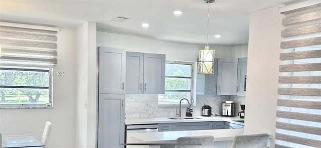 5300 Washington St Unit T227, Hollywood, FL 33021 - kitchen with dishwasher, light countertops, a sink, gray cabinetry, and backsplash
