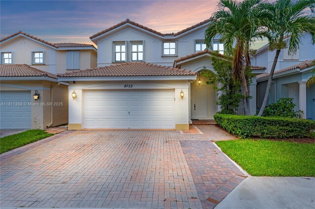 8753 SW 3rd Ln, Miami, FL 33174 - view of front of home featuring stucco siding, a tiled roof, decorative driveway, and a garage