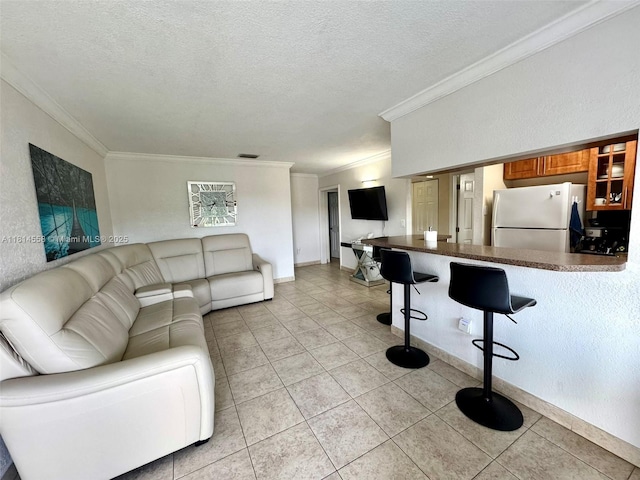 4050 NW 135th St Unit 15-11, Opa-Locka, FL 33054 - living room featuring crown molding, light tile patterned floors, a textured ceiling, and baseboards
