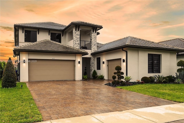 4381 SW 178th Ave, Miramar, FL 33029 - prairie-style house featuring an attached garage, a balcony, stucco siding, decorative driveway, and a tile roof