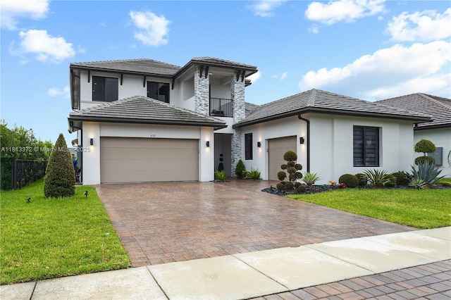 4381 SW 178th Ave, Miramar, FL 33029 - view of front facade featuring an attached garage, a balcony, and stucco siding
