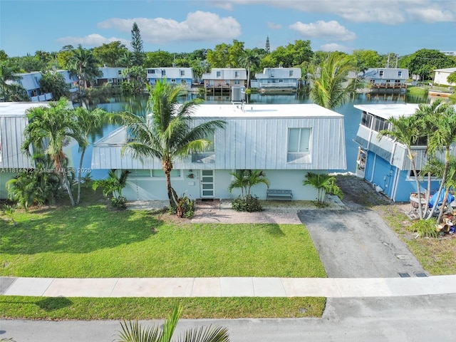 1370 NE 40th Dr, Oakland Park, FL 33334 - view of front of house featuring a water view, a front yard, and a residential view