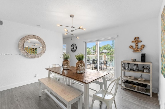 1370 NE 40th Dr, Oakland Park, FL 33334 - dining room featuring a chandelier and wood finished floors