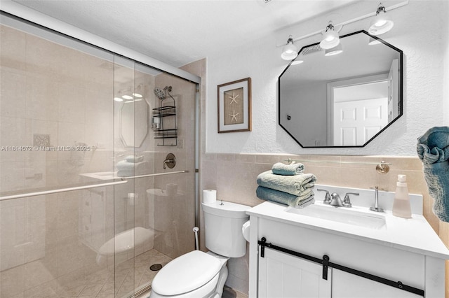 1370 NE 40th Dr, Oakland Park, FL 33334 - full bathroom with vanity, a stall shower, tile walls, a wainscoted wall, and a textured wall