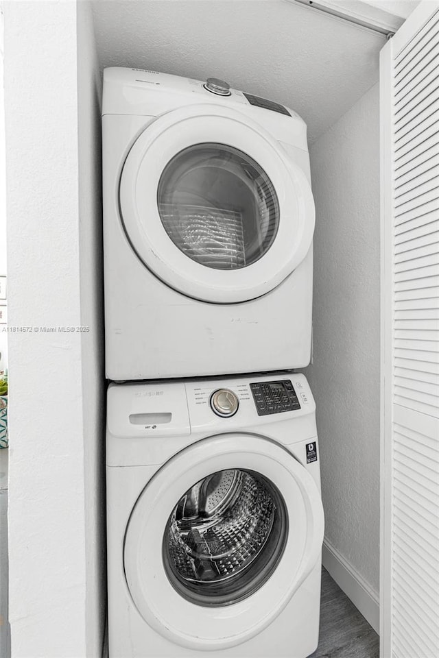 1370 NE 40th Dr, Oakland Park, FL 33334 - laundry area featuring stacked washing machine and dryer and a textured wall