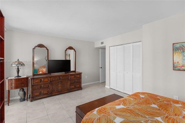 5845 Collins Ave Unit 501, Miami Beach, FL 33140 - bedroom featuring a closet, light tile patterned floors, and baseboards