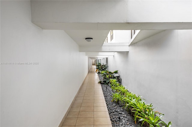 5845 Collins Ave Unit 501, Miami Beach, FL 33140 - corridor featuring light tile patterned floors and baseboards