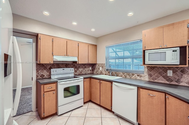 9802 N Military Trl, Palm Beach Gardens, FL 33410 - kitchen featuring white appliances, under cabinet range hood, a sink, dark countertops, and light tile patterned flooring