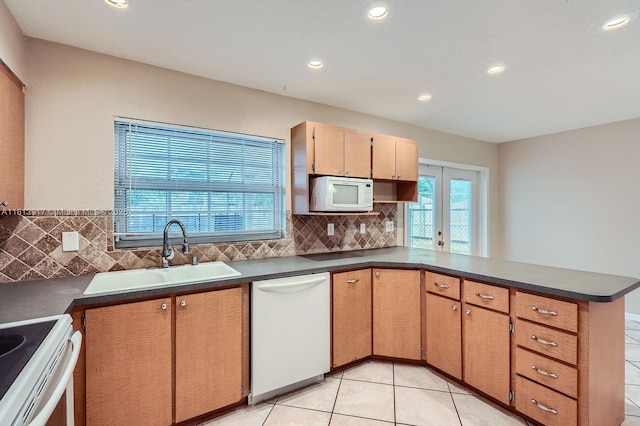 9802 N Military Trl, Palm Beach Gardens, FL 33410 - kitchen featuring white appliances, a sink, backsplash, dark countertops, and recessed lighting