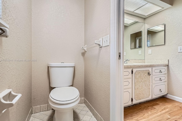 9802 N Military Trl, Palm Beach Gardens, FL 33410 - bathroom featuring toilet, vanity, and baseboards