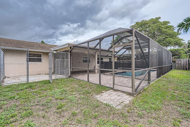 9802 N Military Trl, Palm Beach Gardens, FL 33410 - rear view of property featuring a patio, stucco siding, and glass enclosure