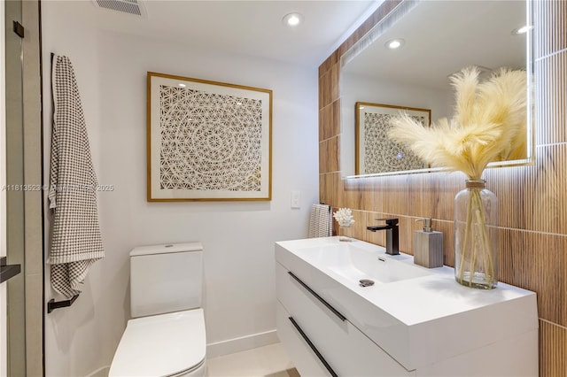 6301 Collins Ave Unit 1405, Miami Beach, FL 33141 - bathroom featuring vanity, decorative backsplash, recessed lighting, and tile walls
