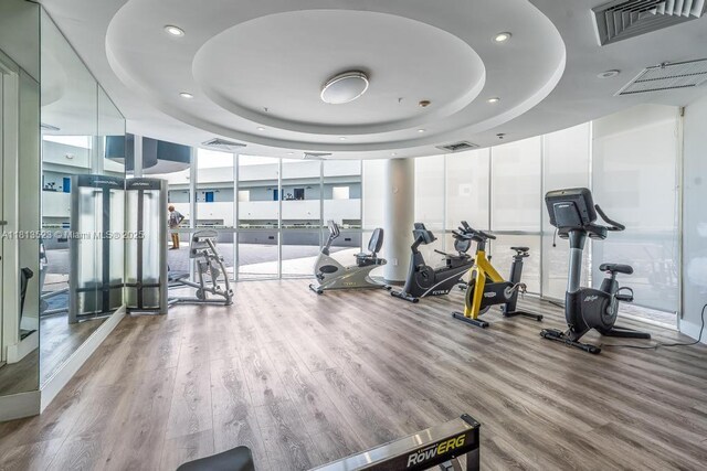 6301 Collins Ave Unit 1405, Miami Beach, FL 33141 - exercise room with a raised ceiling, wood finished floors, expansive windows, and recessed lighting