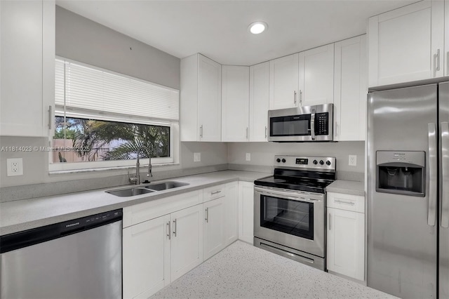 495 SW 183rd Way, Pembroke Pines, FL 33029 - kitchen featuring stainless steel appliances, a sink, white cabinets, speckle patterned floor, and recessed lighting