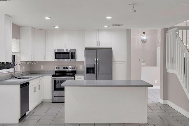 495 SW 183rd Way, Pembroke Pines, FL 33029 - kitchen featuring appliances with stainless steel finishes, a sink, light tile patterned floors, white cabinetry, and recessed lighting