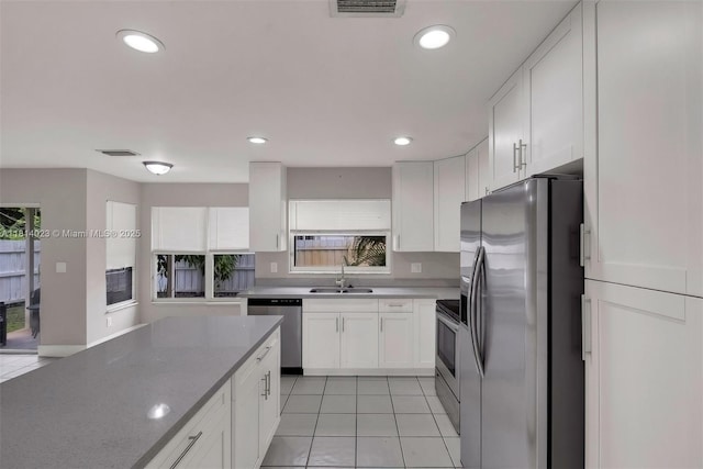 495 SW 183rd Way, Pembroke Pines, FL 33029 - kitchen with stainless steel appliances, a sink, white cabinetry, healthy amount of natural light, and recessed lighting
