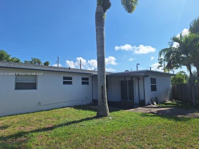 3961 Park Ln, Palm Springs, FL 33406 - rear view of property featuring stucco siding