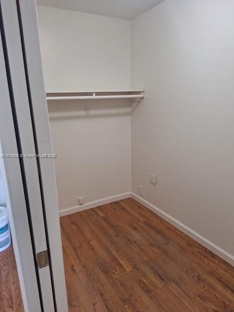 3961 Park Ln, Palm Springs, FL 33406 - walk in closet with wood finished floors