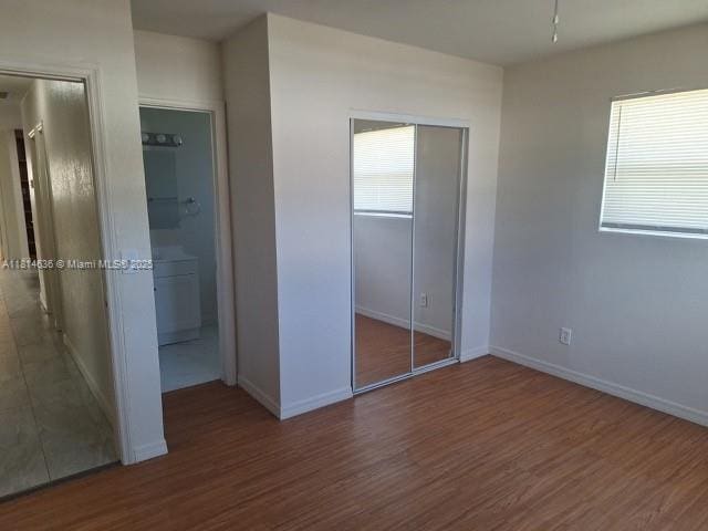 3961 Park Ln, Palm Springs, FL 33406 - unfurnished bedroom featuring wood finished floors and ensuite bath