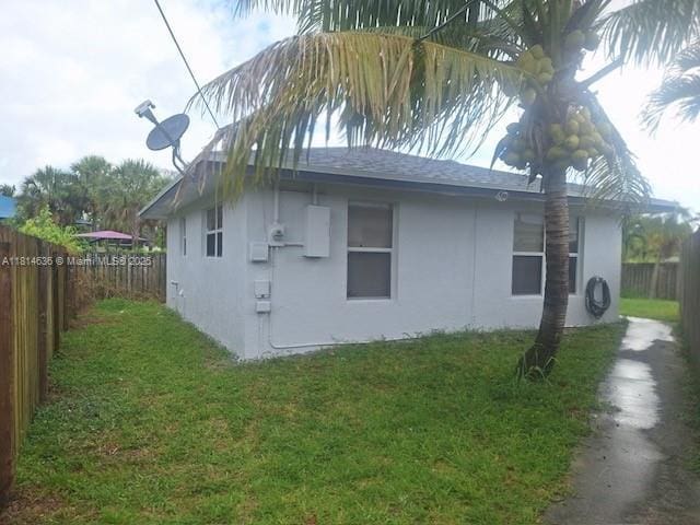 3961 Park Ln, Palm Springs, FL 33406 - view of side of home with stucco siding and a fenced backyard