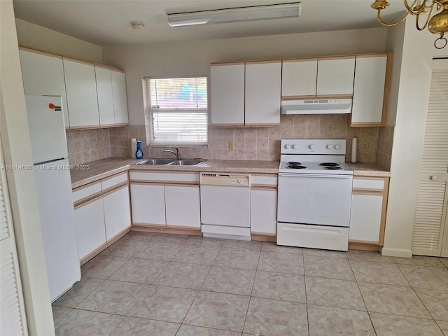 3961 Park Ln, Palm Springs, FL 33406 - kitchen with white appliances, under cabinet range hood, light countertops, tasteful backsplash, and white cabinets