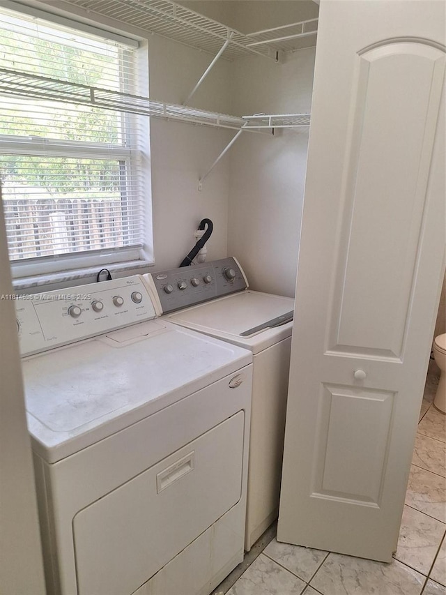 3961 Park Ln, Palm Springs, FL 33406 - laundry room with separate washer and dryer and light marble finish floors