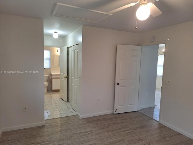 3961 Park Ln, Palm Springs, FL 33406 - unfurnished bedroom featuring connected bathroom and light wood-type flooring