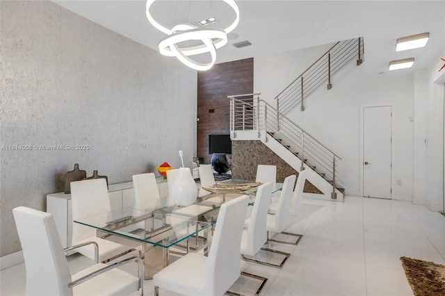 7535 NW 102nd Ct, Doral, FL 33178 - dining room featuring a chandelier, stairs, and a towering ceiling