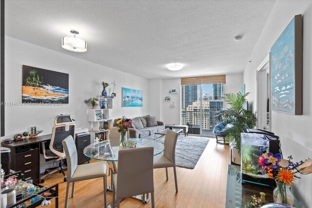 1250 S Miami Ave Unit 2208, Miami, FL 33130 - dining area featuring a textured ceiling and wood finished floors