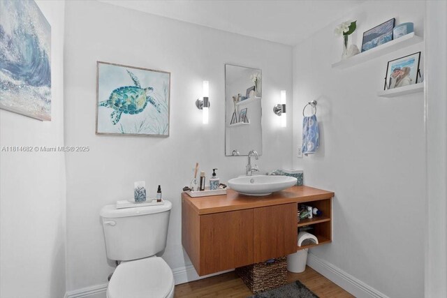 1250 S Miami Ave Unit 2208, Miami, FL 33130 - bathroom with vanity, toilet, wood finished floors, and baseboards