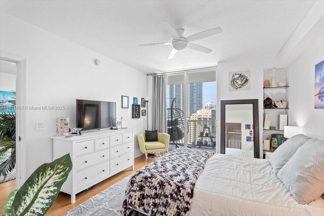1250 S Miami Ave Unit 2208, Miami, FL 33130 - bedroom with light wood-style floors, ceiling fan, and access to outside