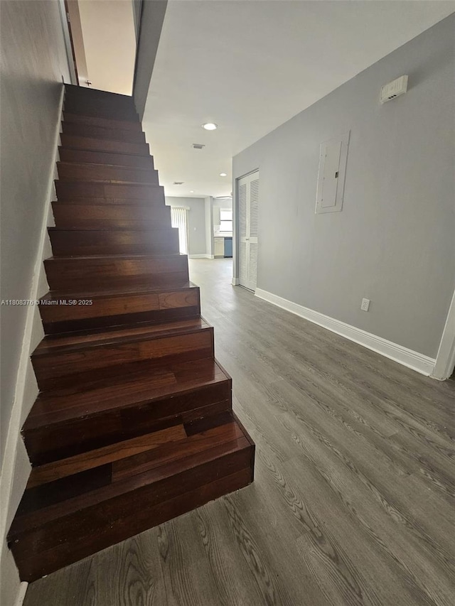 4131 NW 79th Ave Unit 4131, Sunrise, FL 33351 - stairs featuring wood finished floors, baseboards, recessed lighting, and electric panel