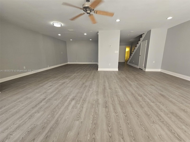 4131 NW 79th Ave Unit 4131, Sunrise, FL 33351 - unfurnished living room featuring stairway, ceiling fan, baseboards, wood finished floors, and recessed lighting