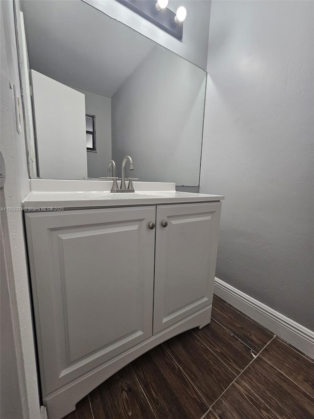 4131 NW 79th Ave Unit 4131, Sunrise, FL 33351 - bathroom featuring baseboards, vanity, and wood finished floors