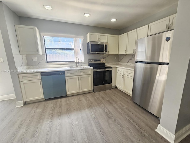 4131 NW 79th Ave Unit 4131, Sunrise, FL 33351 - kitchen featuring stainless steel appliances, a sink, light countertops, light wood finished floors, and recessed lighting