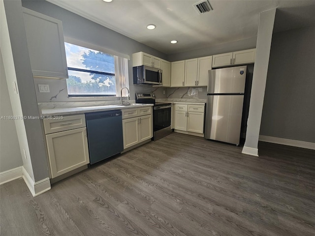 4131 NW 79th Ave Unit 4131, Sunrise, FL 33351 - kitchen with stainless steel appliances, light countertops, dark wood-type flooring, a sink, and recessed lighting