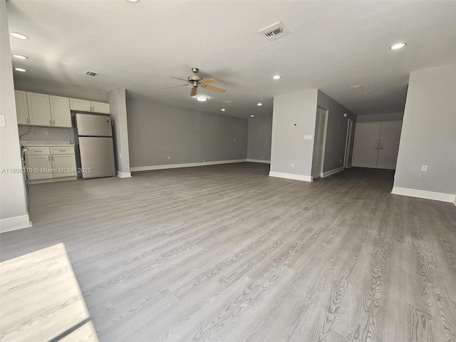 4131 NW 79th Ave Unit 4131, Sunrise, FL 33351 - unfurnished living room with a ceiling fan, recessed lighting, baseboards, and light wood-style flooring