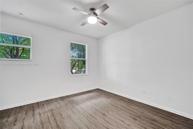 4284 Cascada Cir, Cooper City, FL 33024 - unfurnished room with wood finished floors, plenty of natural light, a ceiling fan, and baseboards
