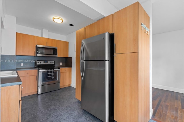 1105 NE 119th St, Biscayne Park, FL 33161 - kitchen with stainless steel appliances, backsplash, and dark tile patterned floors