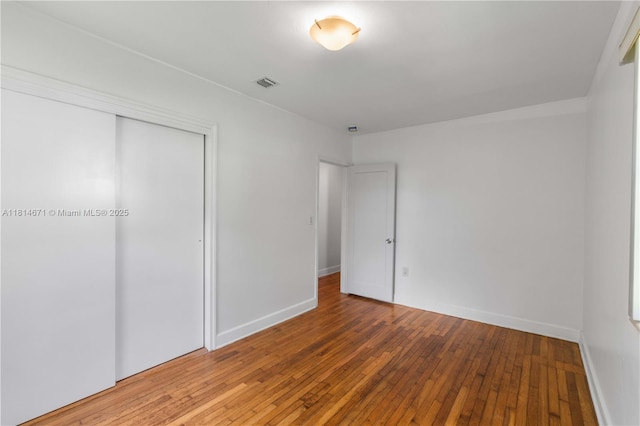 1105 NE 119th St, Biscayne Park, FL 33161 - unfurnished bedroom featuring hardwood / wood-style floors and a closet