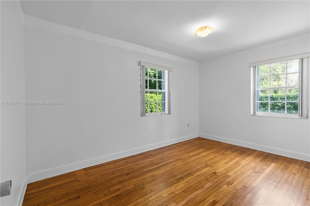 1105 NE 119th St, Biscayne Park, FL 33161 - spare room featuring hardwood / wood-style floors and baseboards