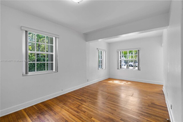 1105 NE 119th St, Biscayne Park, FL 33161 - spare room with baseboards and hardwood / wood-style floors