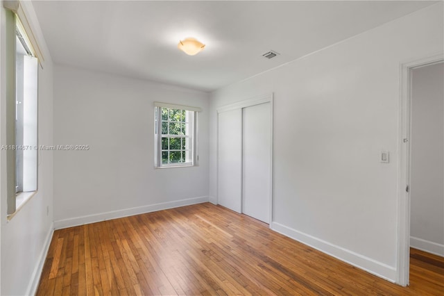 1105 NE 119th St, Biscayne Park, FL 33161 - unfurnished bedroom with a closet and hardwood / wood-style floors