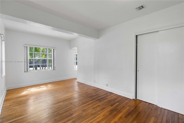 1105 NE 119th St, Biscayne Park, FL 33161 - spare room featuring wood-type flooring and arched walkways
