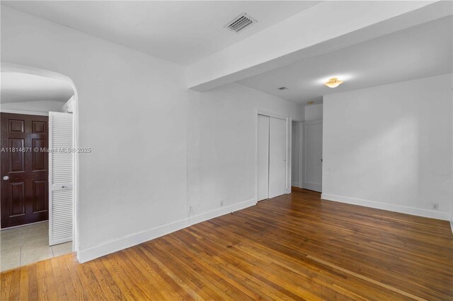 1105 NE 119th St, Biscayne Park, FL 33161 - empty room with hardwood / wood-style flooring and arched walkways